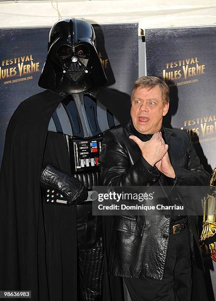 Actor Mark Hamill poses with Darth Vader as he attends a Tribute to Star Wars V during the 18th Adventure Film Festival at Le Grand Rex on April 23,...