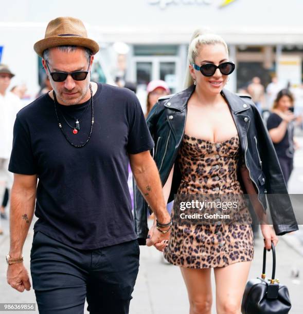 Lady Gaga and Christian Carino walk to her studio on June 28, 2018 in New York City.