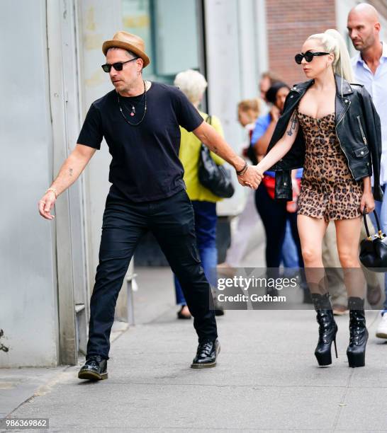 Lady Gaga and Christian Carino walk to her studio on June 28, 2018 in New York City.