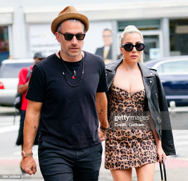 Lady Gaga and Christian Carino walk to her studio on June 28, 2018 in New York City.