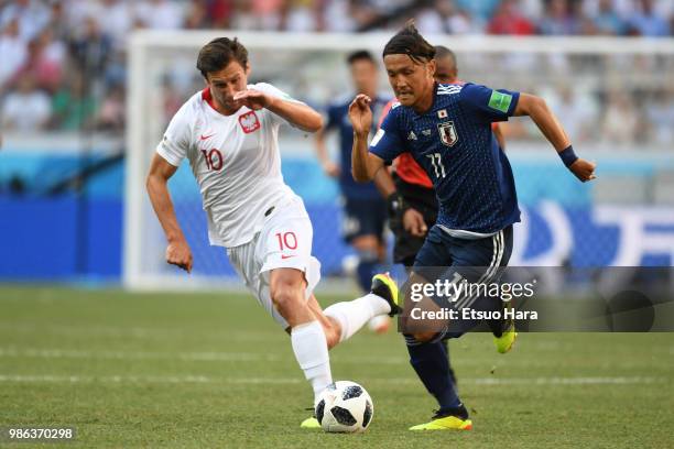 Takashi Usami of Japan and Grzegorz Krychowiak of Poland compete for the ball during the 2018 FIFA World Cup Russia group H match between Japan and...