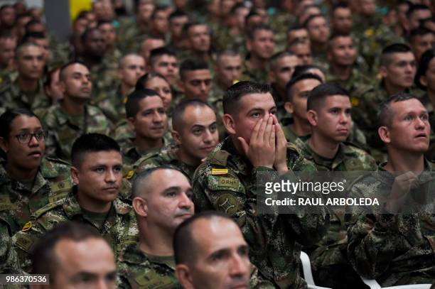Members of the Colombian army watch the FIFA World Cup match between Colombia and Senegal, at a military base in Tolemaida, Colombia, on June 28,...