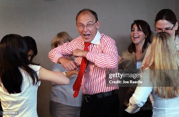 Volker Frank Sperlich, a certifies laughter leader, takes a class through a therapeutic laughter session during the Integrative Medicine symposium at...