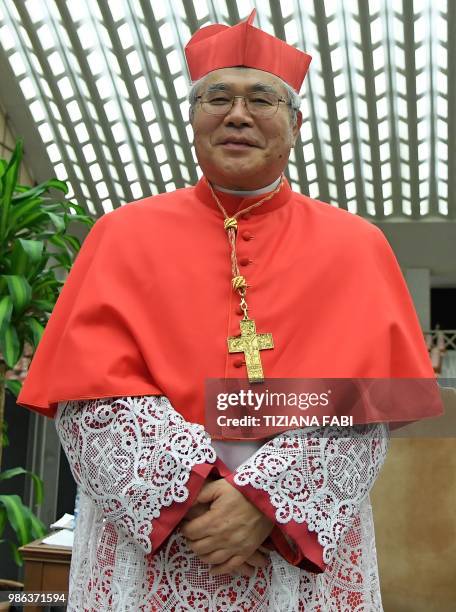 Japan's Thomas Aquino Manyo Maeda poses as he attends the courtesy visit of relatives following a consistory for the creation of new cardinals in the...