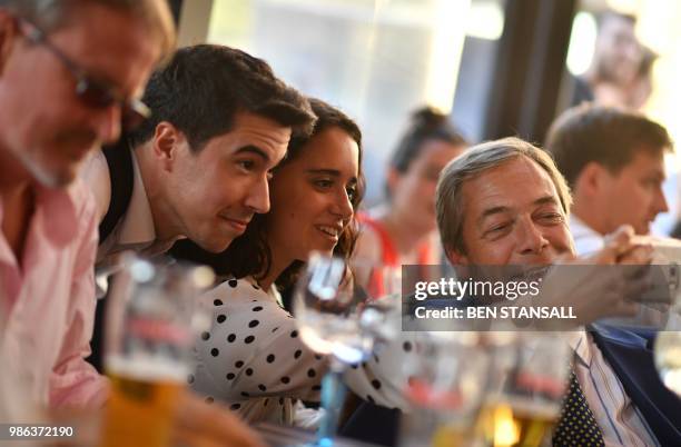 British politician Nigel Farage poses for a 'selfie' at The Beer Factory Bar in Brussels on June 28 as he watches the Russia 2018 World Cup Group G...