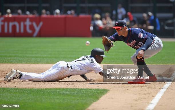 Tim Anderson of the Chicago White Sox dives back to first base ahead of the throw to Logan Morrison of the Minnesota Twins in the 3rd inning at...