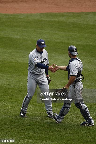 Trevor Hoffman of the Milwaukee Brewers celebrates a victory with George Kottaras of the Milwaukee Brewers during the game between the Milwaukee...