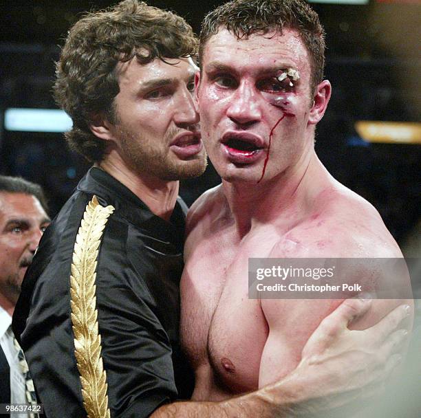 Wladamir Klitschko, left, and brother Vitali Klitschko, right, talk after a 12-round WBC/IBO Heavyweight Championship held at the Staples Center in...