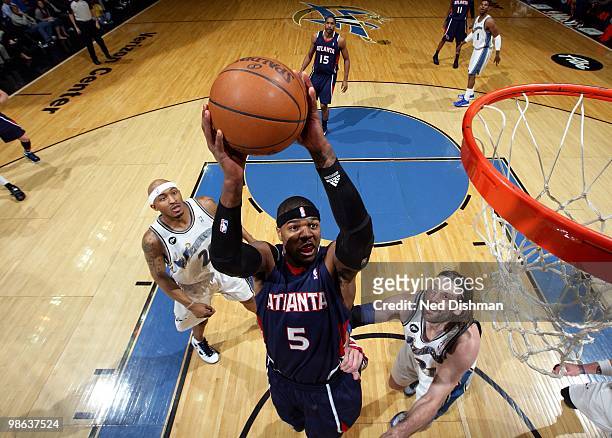 Josh Smith of the Atlanta Hawks goes up for a shot against Fabricio Oberto and James Singleton of the Washington Wizards during the game at the...