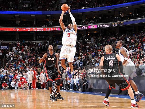 Andre Iguodala of the Philadelphia 76ers shoots a jump shot against Dorell Wright and Carlos Arroyo of the Miami Heat during the game at Wachovia...