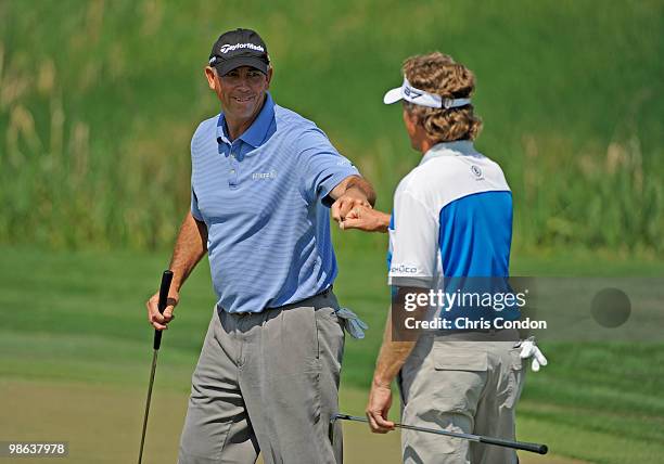 Tom Lehman and Bernhard Langer of Germany celebrate a birdie on during the first round round of the Legends Division at the Liberty Mutual Legends of...