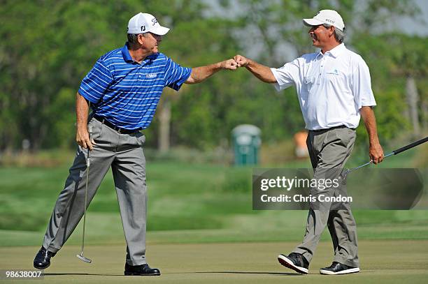 Jay Haas and Fred Couples celebrate a birdie on during the first round round of the Legends Division at the Liberty Mutual Legends of Golf at The...