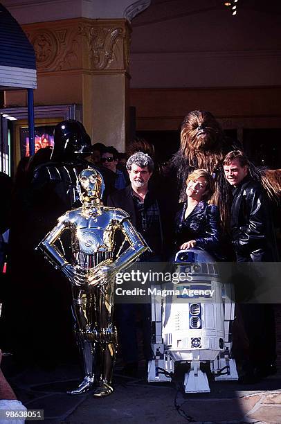 George Lucas, Carrie Fisher and Mark Hamill with R2-D2, Darth Vader, C-3PO and Chewbacca