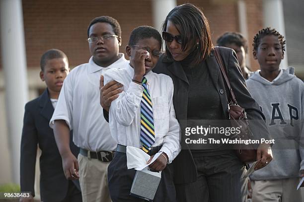 Students, teachers, family and friends attend the wake for Shaw at Garnet-Patterson Middle School principal Brian Betts who was slain in his Silver...
