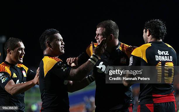 Toby Smith of the Chiefs celebrates with Hika Elliot and Stephen Donald after scoring during the round 11 Super 14 match between the Chiefs and the...