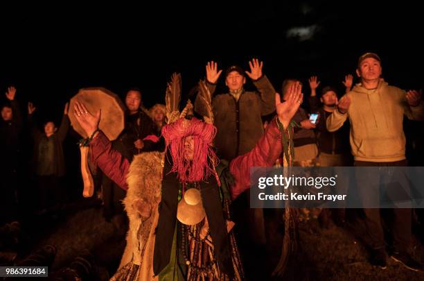 Mongolian Shaman or Buu, and followers take part in a fire ritual meant to summon spirits to mark the period of the Summer Solstice early June 24,...