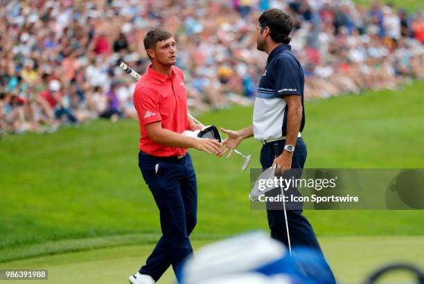 Bryson DeChambeau of the United States shakes hands with Bubba Watson of the United States during the Final Round of the Travelers Championship on...