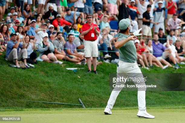 Jason Day of Australia throws his ball to the crowd after chipping in oil 18 during the Final Round of the Travelers Championship on June 24, 2018 at...