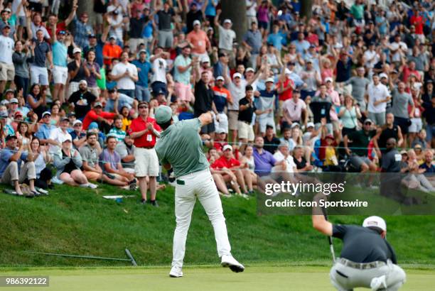 Jason Day of Australia tosses his ball into the gallery after chipping in on 18 during the Final Round of the Travelers Championship on June 24, 2018...