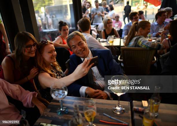 British politician Nigel Farage poses for a 'selfie' at The Beer Factory Bar in Brussels on June 28 as he watches the Russia 2018 World Cup Group G...