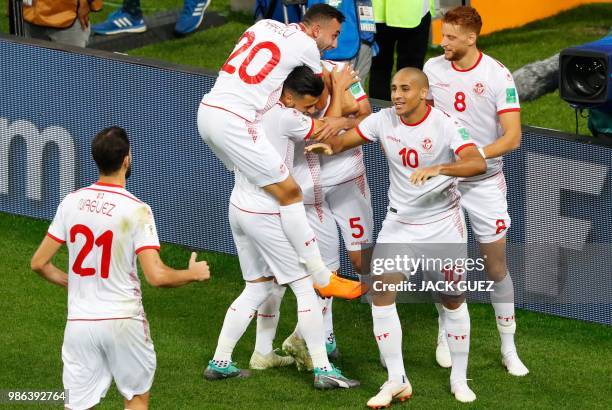 Tunisia's forward Wahbi Khazri celebrates with teammates after scoring during the Russia 2018 World Cup Group G football match between Panama and...
