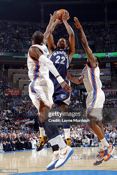 Rudy Gay of the Memphis Grizzlies shoots a jump shot against Kevin Durant and James Harden of the Oklahoma City Thunder during the game at Ford...