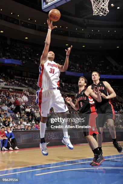 Charlie Villanueva of the Detroit Pistons puts up a shot against Jose Calderon and Rasho Nesterovic of the Toronto Raptors during the game at the...