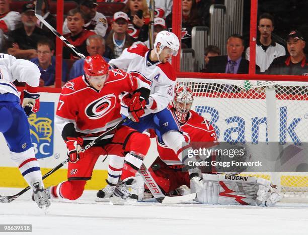 Cam Ward of the Carolina Hurricanes makes a save through traffic in the crease created by Brian Gionta of the Montreal Canadiens during a NHL game on...