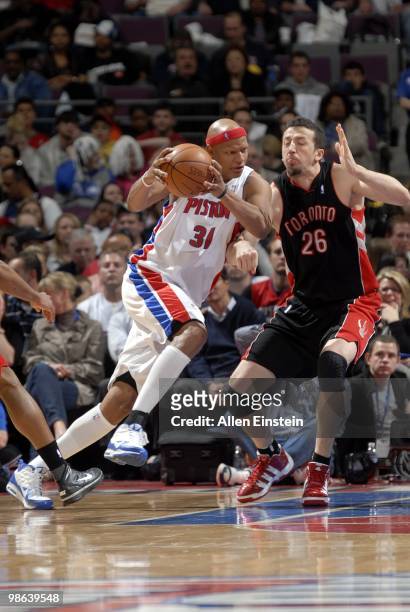 Charlie Villanueva of the Detroit Pistons drives to the basket against Hedo Turkoglu of the Toronto Raptors during the game at the Palace of Auburn...