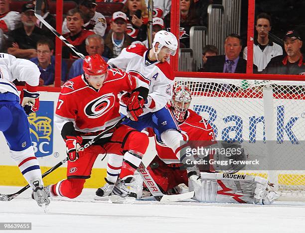Cam Ward of the Carolina Hurricanes makes a save through traffic in the crease created by Brian Gionta of the Montreal Canadiens during a NHL game on...