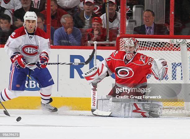 Cam Ward of the Carolina Hurricanes prepares to make a save behind Scott Gomez of the Montreal Canadiens during a NHL game on April 8, 2010 at RBC...