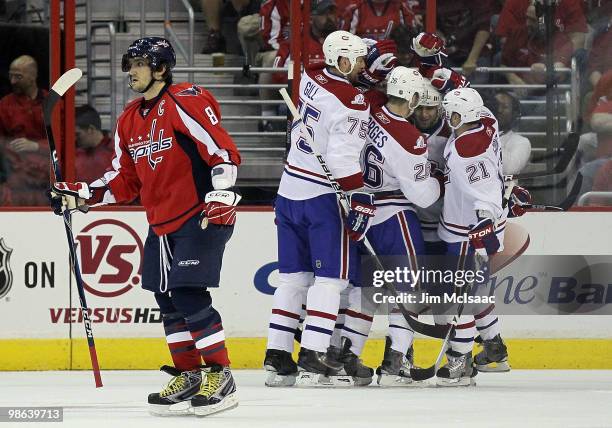 Alex Ovechkin of the Washington Capitals skates away as the Montreal Canadiens celebrate their second goal of the first period scored by Travis Moen...