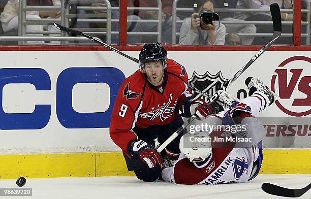 Brendan Morrison of the Washington Capitals battles fpr the puck against Roman Hamrlik of the Montreal Canadiens in Game Five of the Eastern...