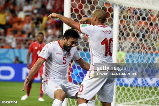 Tunisia's forward Wahbi Khazri is congratulated by teammates after scoring a goal during the Russia 2018 World Cup Group G football match between...