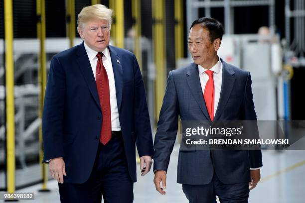 President Donald Trump and Foxconn Chairman Terry Gou tour a Foxconn facility at the Wisconsin Valley Science and Technology Park June 28, 2018 in...