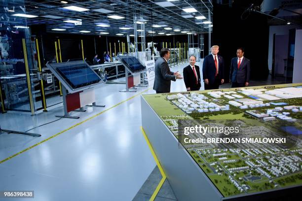 Masayoshi Son , Chief Executive Officer of SoftBank, US President Donald Trump , and Foxconn Chairman Terry Gou tours a Foxconn facility at the...