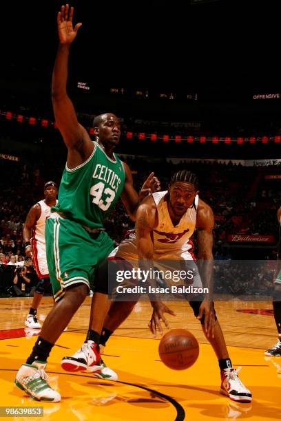 Udonis Haslem of the Miami Heat drives against Kendrick Perkins of the Boston Celtics in Game Three of the Eastern Conference Quarterfinals during...