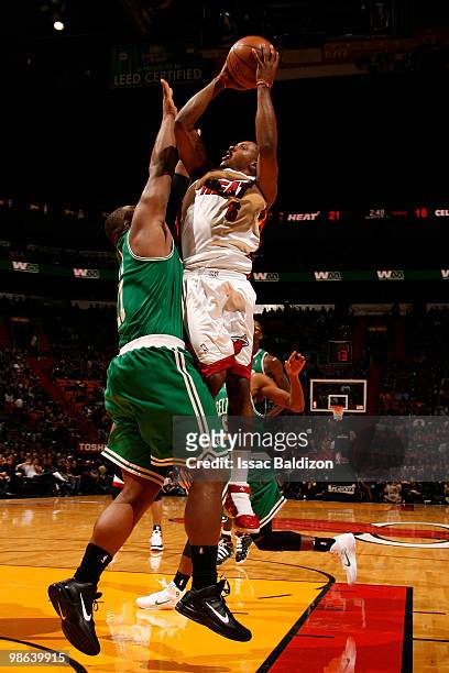 Mario Chalmers of the Miami Heat shoots against Glen Davis of the Boston Celtics in Game Three of the Eastern Conference Quarterfinals during the...