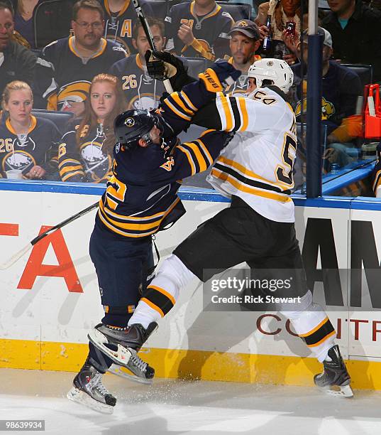 Nathan Gerbe of the Buffalo Sabres and Adam McQuaid of the Boston Bruins collide in Game Five of the Eastern Conference Quarterfinals during the 2010...