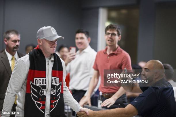 English soccer player Wayne Rooney arrives at Dulles International Airport on June 28, 2018 in Dulles, Virginia. - Rooney will join Major League...