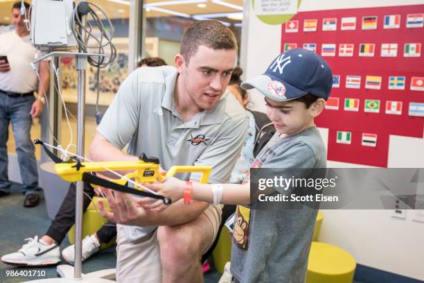 Connor Keating of the Denver Outlaws plays Battleship Archery with Jordan at Boston Children's Hospital on June 28, 2018 in Boston, Massachusetts.