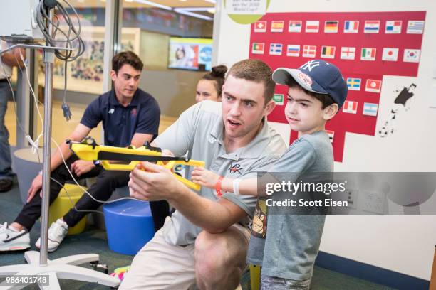 Connor Keating of the Denver Outlaws plays Battleship Archery with Jordan at Boston Children's Hospital on June 28, 2018 in Boston, Massachusetts.