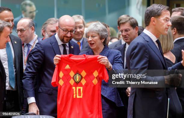 Belgium Prime Minister Charles Michel is giving a Belgium national football team of Eden Hazard to the Prime Minister of the United Kingdom Theresa...