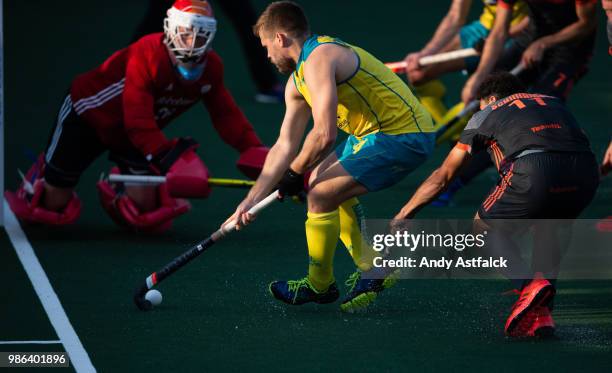 Aaron Kleinschmidt from Australia dribbles towards goal while being pursued by Glenn Schuurman from The Netherlands during the Netherlands versus...