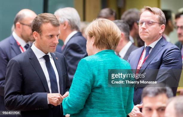 French President Emmanuel Macron is talking with the German Chancellor Angela Merkel during an EU Summit at European Council on June 28, 2018 in...