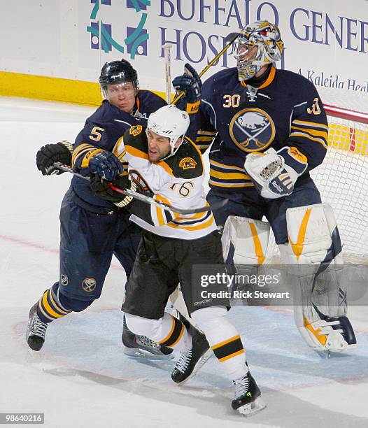 Toni Lydman and Ryan Miller of the Buffalo Sabres defend against Steve Begin of the Boston Bruins in Game Five of the Eastern Conference...