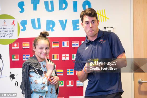 Cody Radziewicz of the Dallas Rattlers plays Battleship Archery with Giselle at Boston Children's Hospital on June 28, 2018 in Boston, Massachusetts.