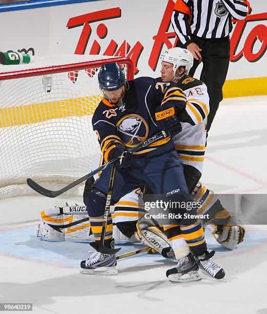 Jason Pominville of the Buffalo Sabres fights for position in front of the net against Matt Hunwick of the Boston Bruins in Game Five of the Eastern...