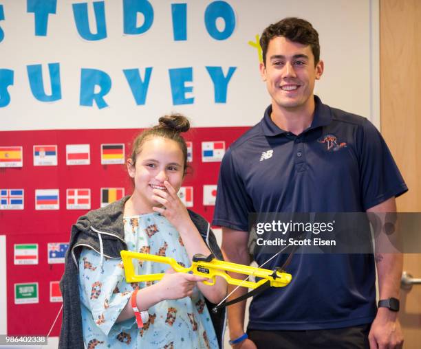 Cody Radziewicz of the Dallas Rattlers plays Battleship Archery with Giselle at Boston Children's Hospital on June 28, 2018 in Boston, Massachusetts.