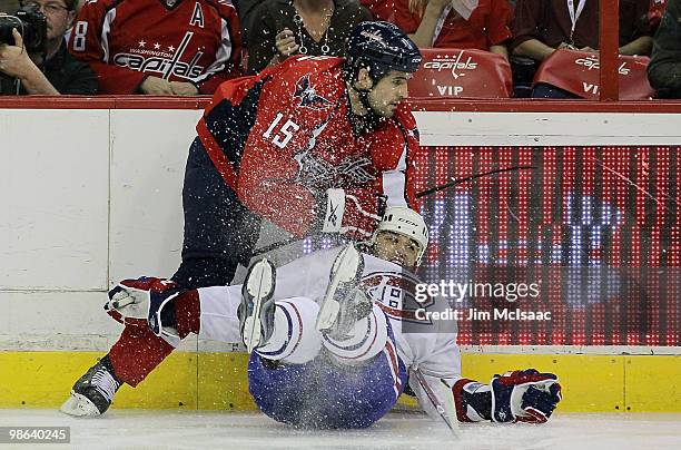 Boyd Gordon of the Washington Capitals takes out Scott Gomez of the Montreal Canadiens in Game Five of the Eastern Conference Quarterfinals during...